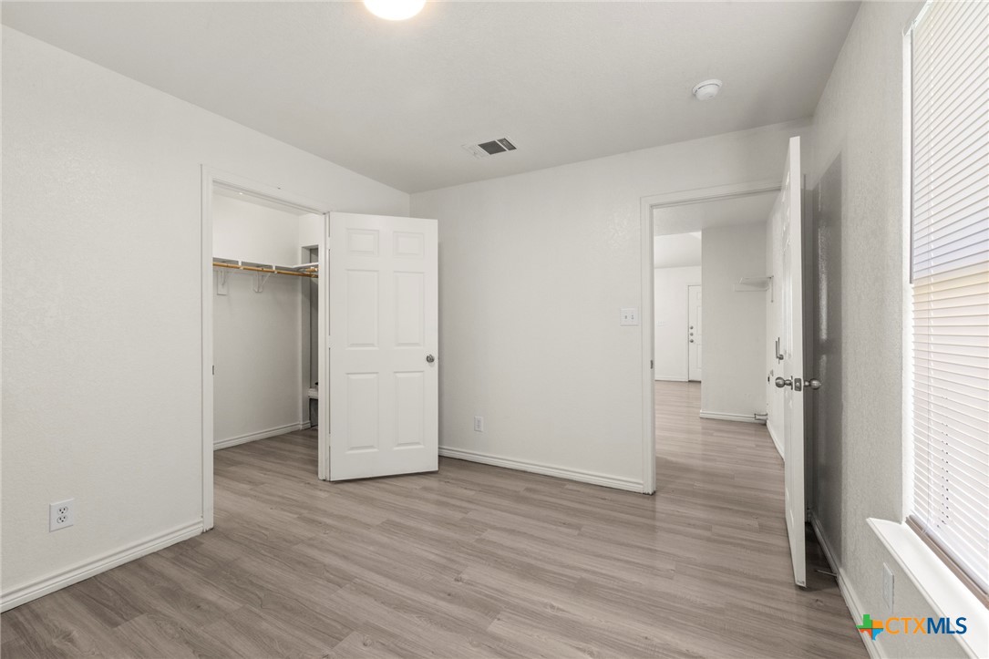 115 North 20th Street Temple, TX 76501 - Photo 5 of 8 an empty room with wooden floor and windows
