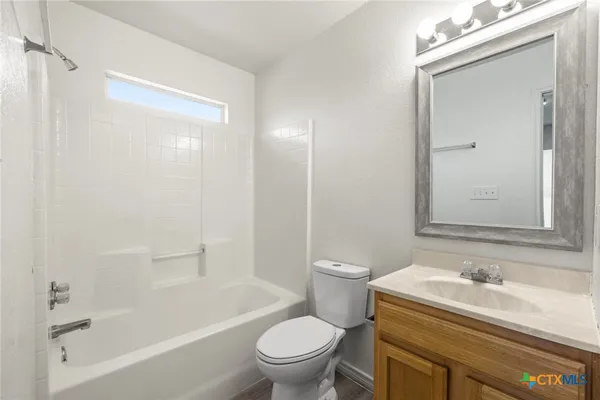 a bathroom with a sink a toilet and a bathtub