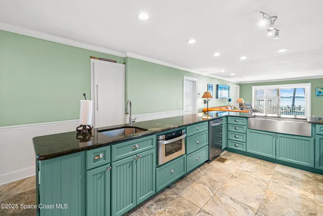 a view of a hallway with wooden floor and a bathroom