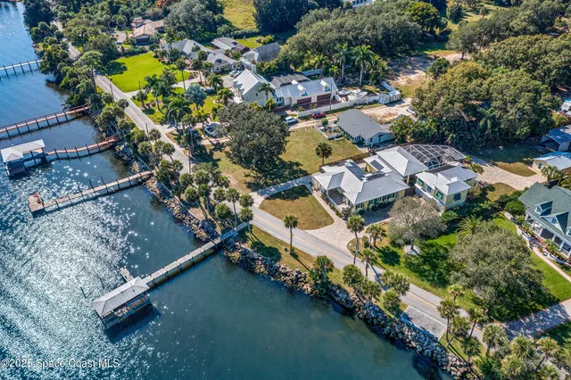 an aerial view of a house with a garden and trees