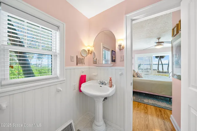 a front view of a house with a garden and trees