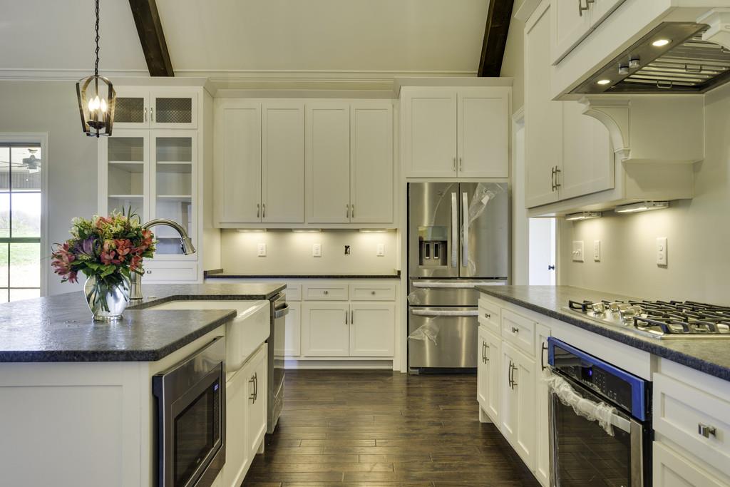 2140 Allisona Road Eagleville, TN 37060 - Photo 18 of 30 a kitchen with stainless steel appliances granite countertop a sink stove and refrigerator