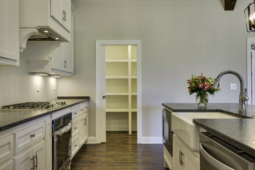 2140 Allisona Road Eagleville, TN 37060 - Photo 19 of 30 a kitchen with granite countertop a sink stove and cabinets