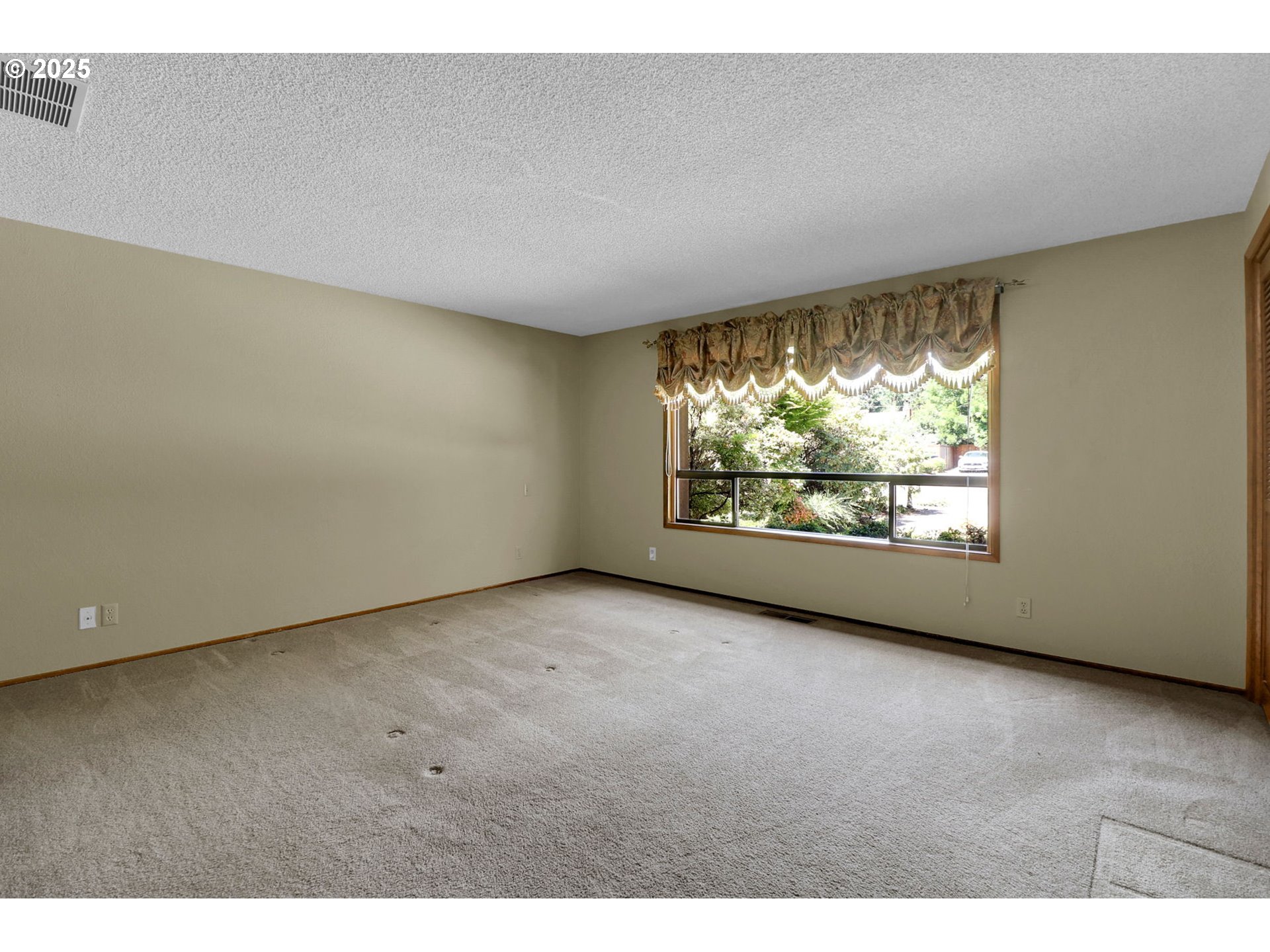 1254 Rio Glen Drive Eugene, OR 97401 - Photo 29 of 43 a view of an empty room with wooden floor and a window