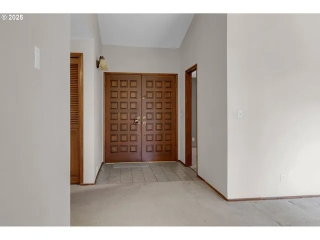 a view of an empty room with a fireplace