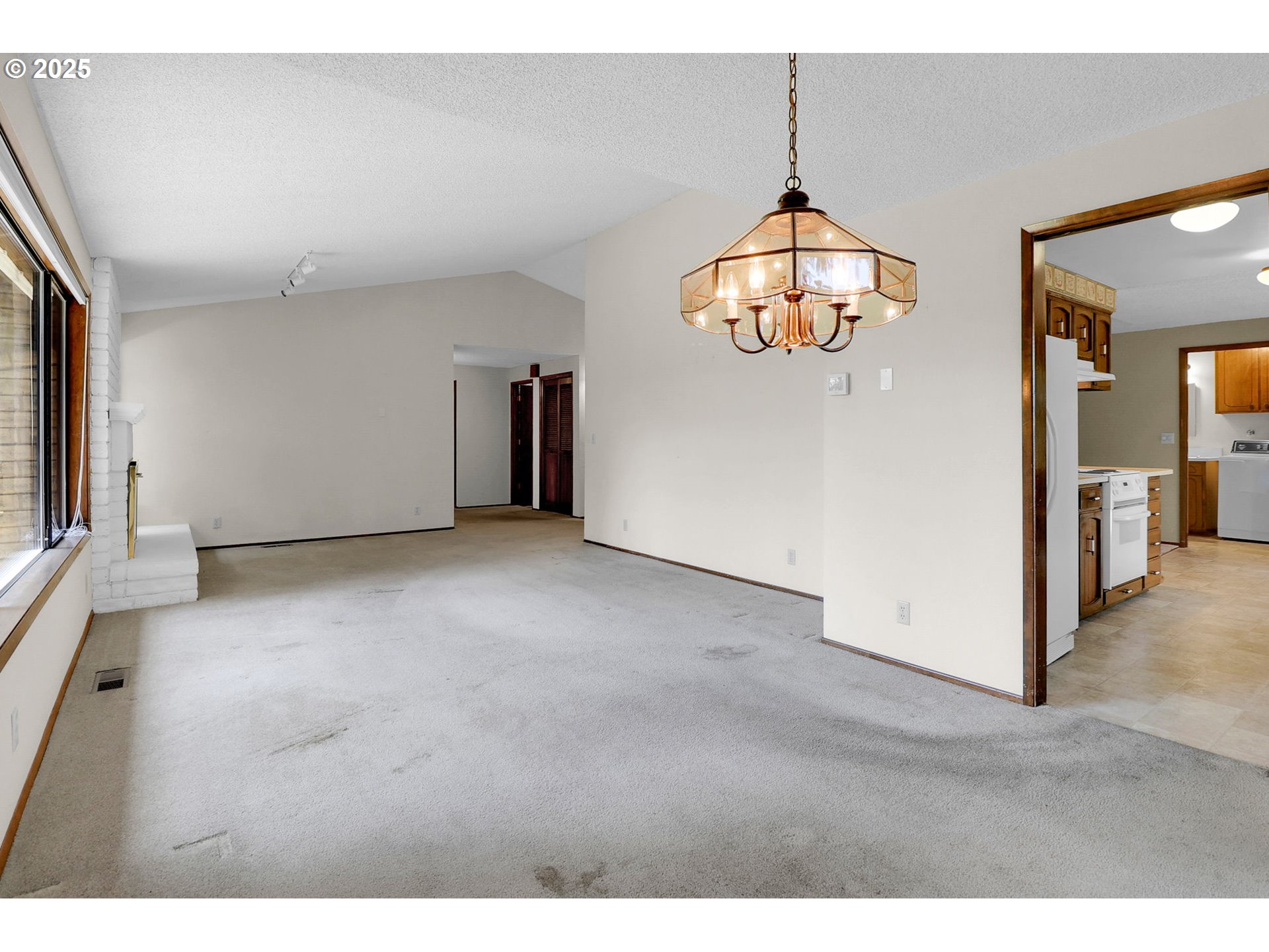 1254 Rio Glen Drive Eugene, OR 97401 - Photo 10 of 43 a view interior of a house with wooden floor windows and a chandelier