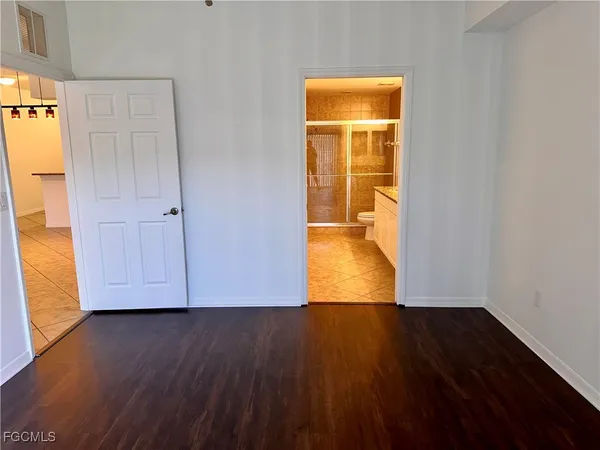 an empty room with wooden floor and closet