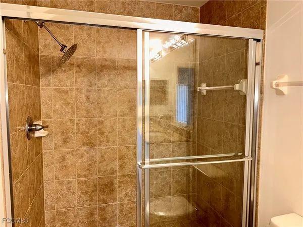 a bathroom with a glass shower door