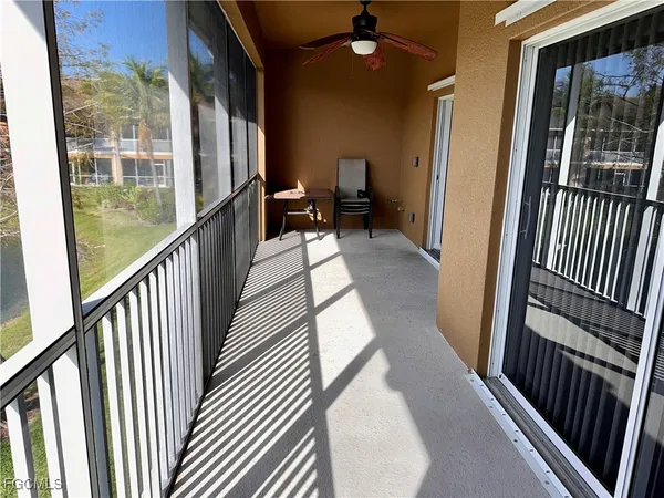 a view of a balcony with floor to ceiling windows with wooden floor