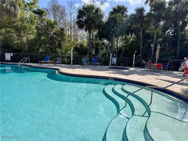 a swimming pool with outdoor seating and yard