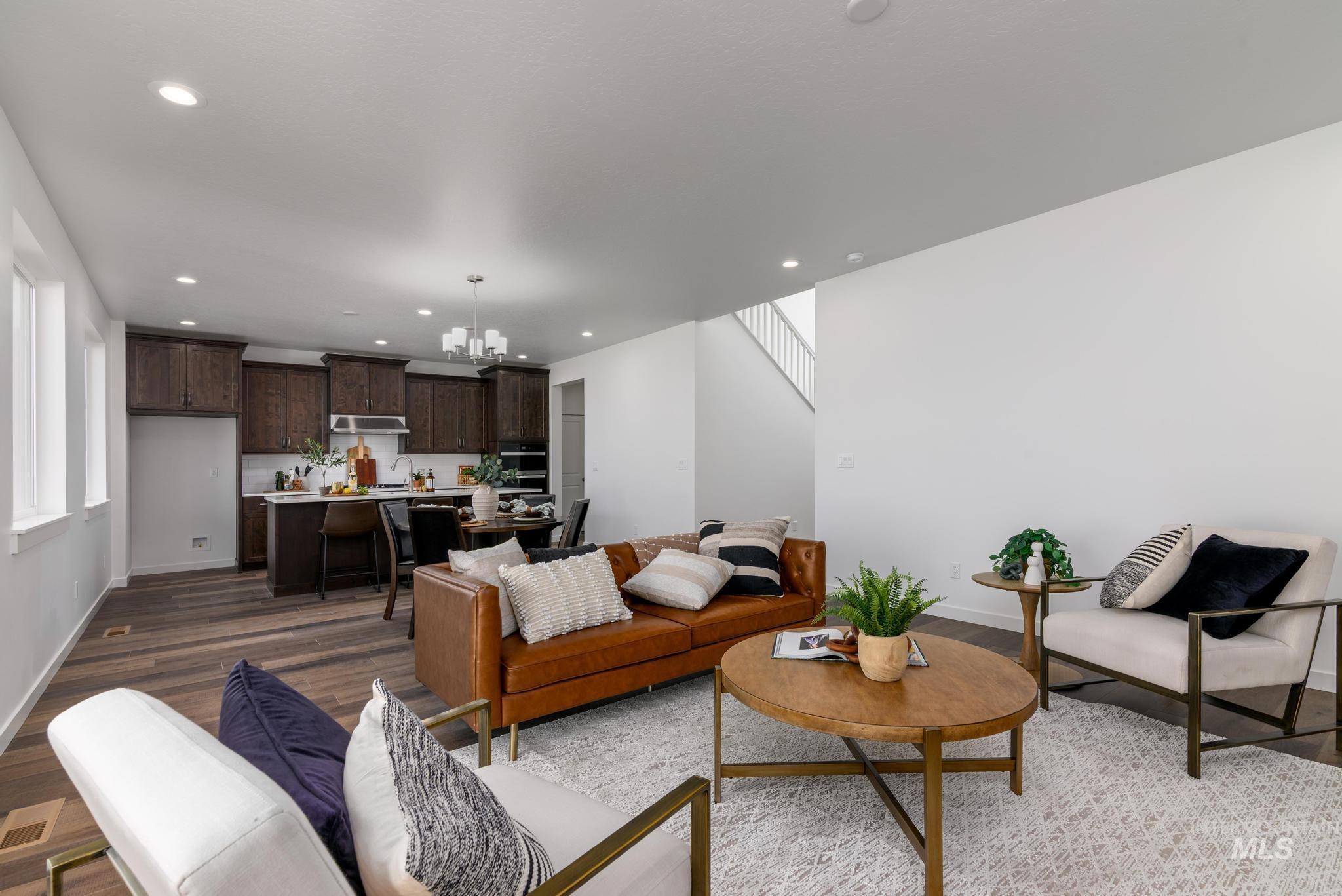 1727 West Arya Street Kuna, ID 83634 - Photo 3 of 18 Living area with wood finished floors, a chandelier, recessed lighting, and stairs