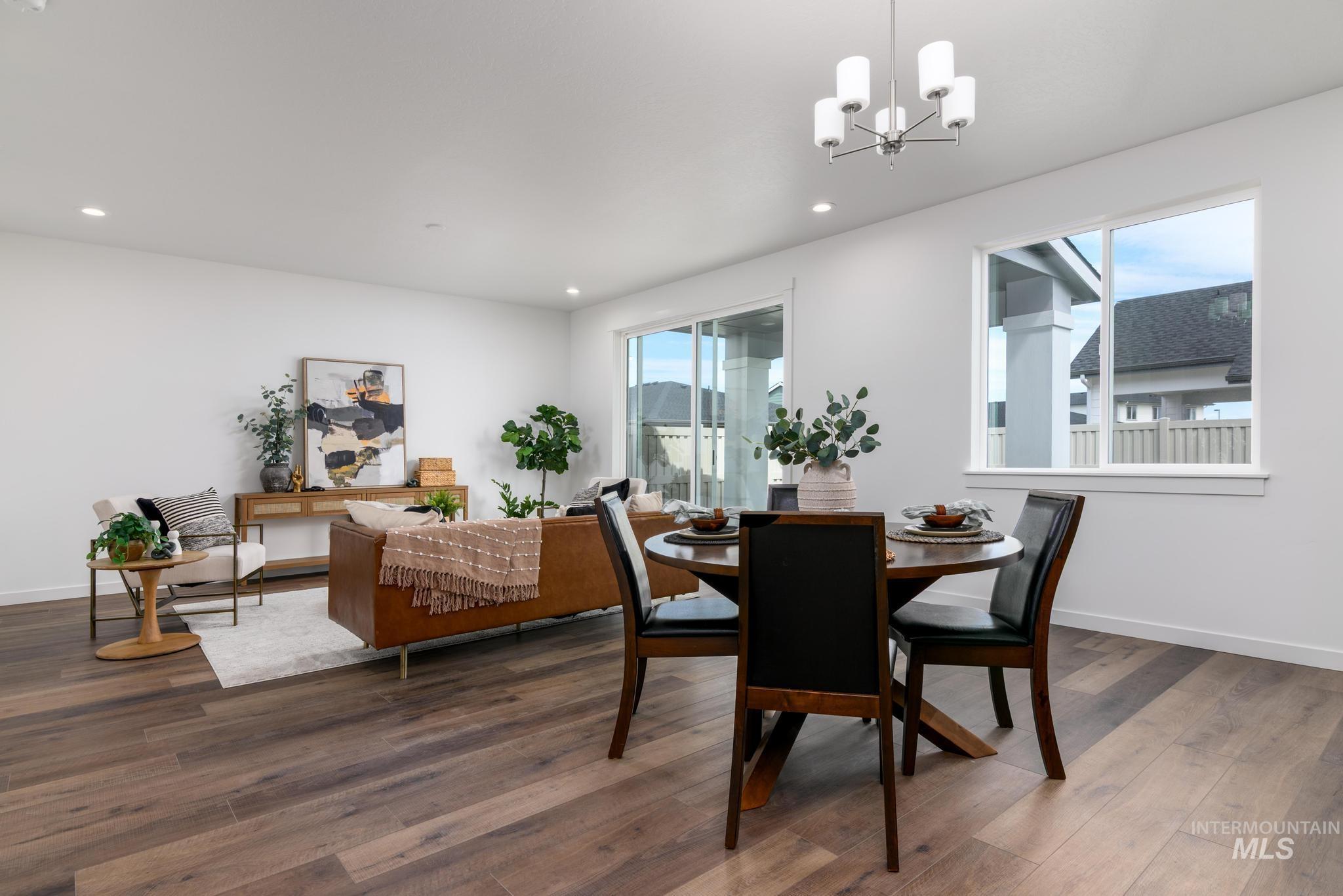 1727 West Arya Street Kuna, ID 83634 - Photo 5 of 18 Dining room featuring a chandelier, wood finished floors, and recessed lighting