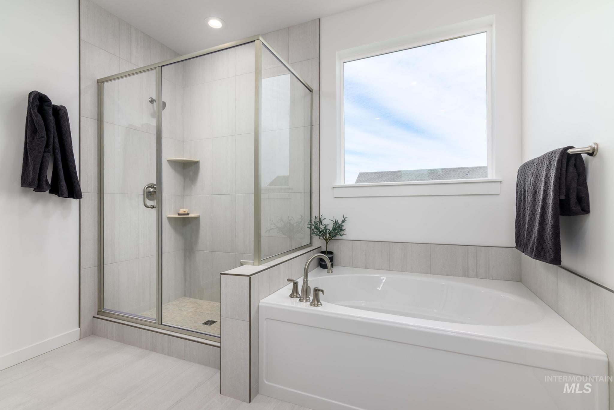1727 West Arya Street Kuna, ID 83634 - Photo 9 of 18 Full bathroom featuring a bath, a shower stall, and recessed lighting