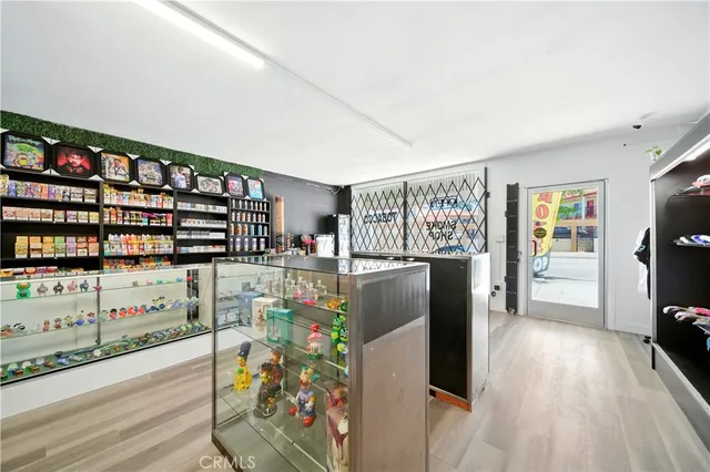 a kitchen with granite countertop a refrigerator and a wooden floor