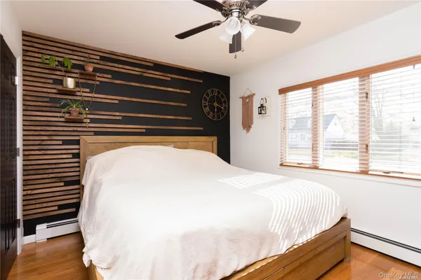 a bed sitting in a bedroom next to a window