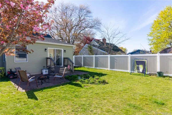 a view of a house with a backyard and a patio