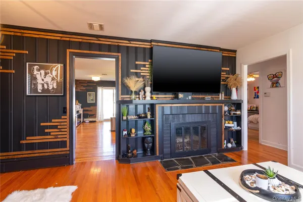 a living room with fireplace furniture and a flat screen tv
