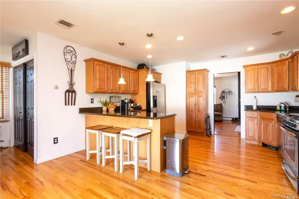 a large white kitchen with lots of counter space and stainless steel appliances