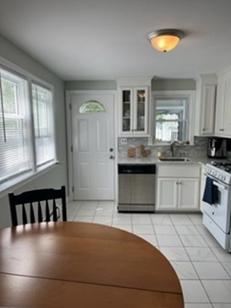 59 Desoto Road Boston, MA 02132 - Photo 3 of 28 a kitchen with granite countertop a stove a sink and a refrigerator