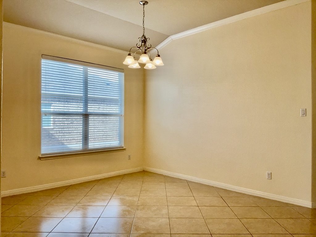 2946 Todd Trail Round Rock, TX 78665 - Photo 11 of 31 Formal dining room with ornamental molding, light tile patterned floors, suspended lighting, and vaulted ceiling