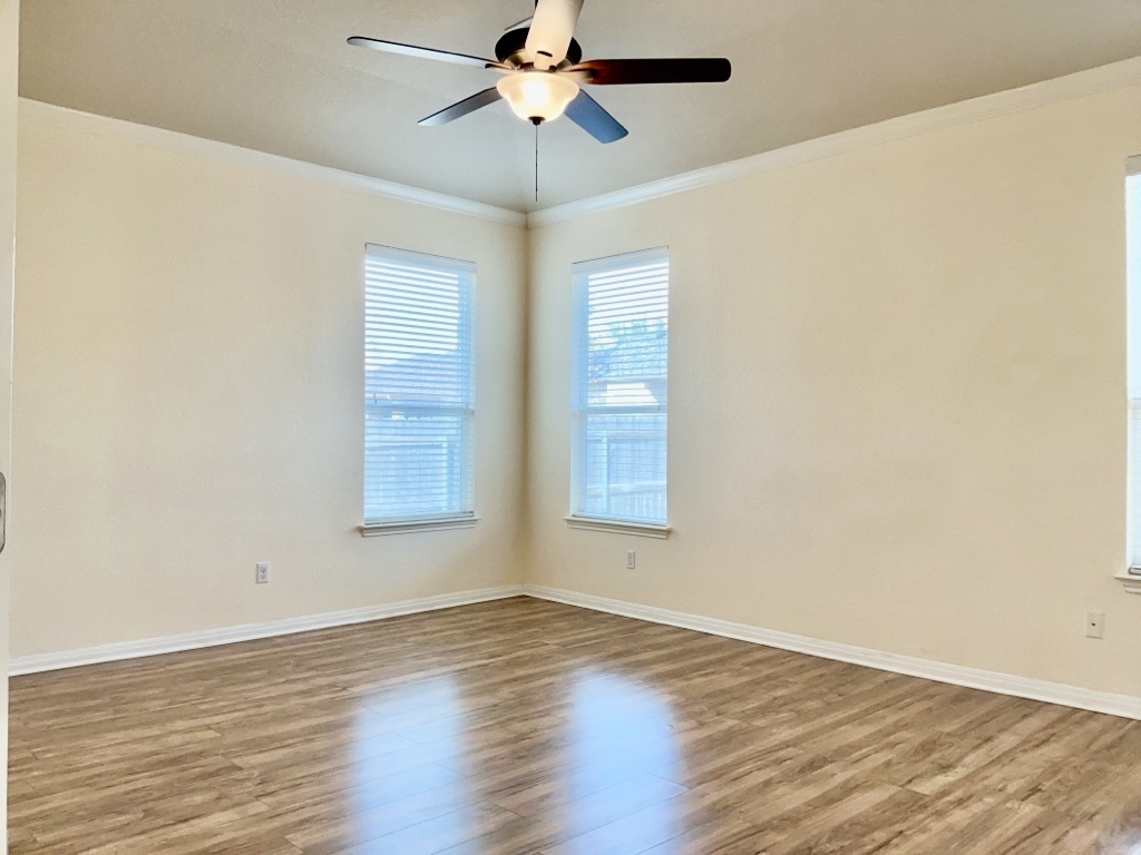 2946 Todd Trail Round Rock, TX 78665 - Photo 14 of 31 Primary bedroom with crown molding, light wood-style floors, and a ceiling fan