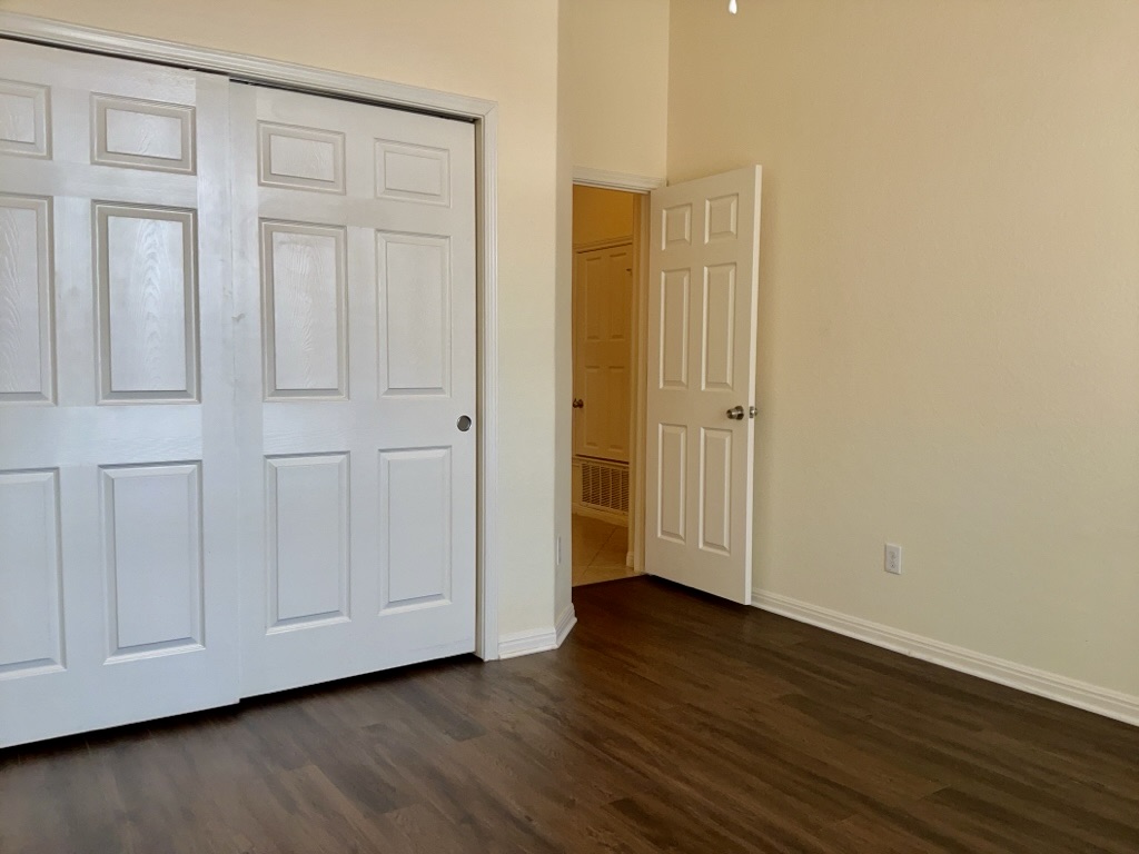 2946 Todd Trail Round Rock, TX 78665 - Photo 20 of 31 Bedroom featuring a closet and dark wood finished floors