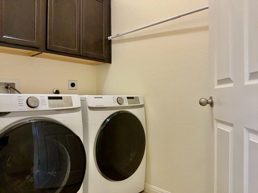 2946 Todd Trail Round Rock, TX 78665 - Photo 21 of 31 Laundry area with cabinet space and separate washer and dryer