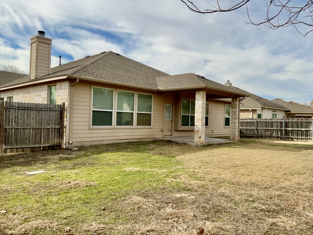 2946 Todd Trail Round Rock, TX 78665 - Photo 31 of 31 Back of property featuring a fenced backyard, a patio area, roof with shingles, and a chimney