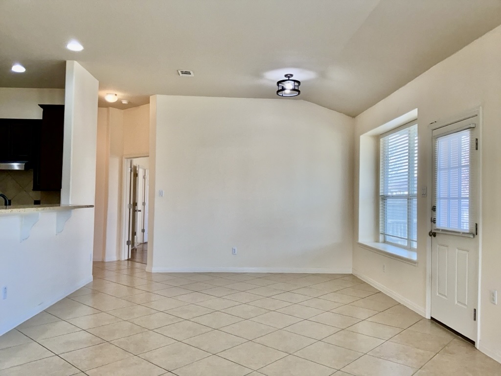 2946 Todd Trail Round Rock, TX 78665 - Photo 9 of 31 Dining Area with vaulted ceiling and light tile patterned flooring