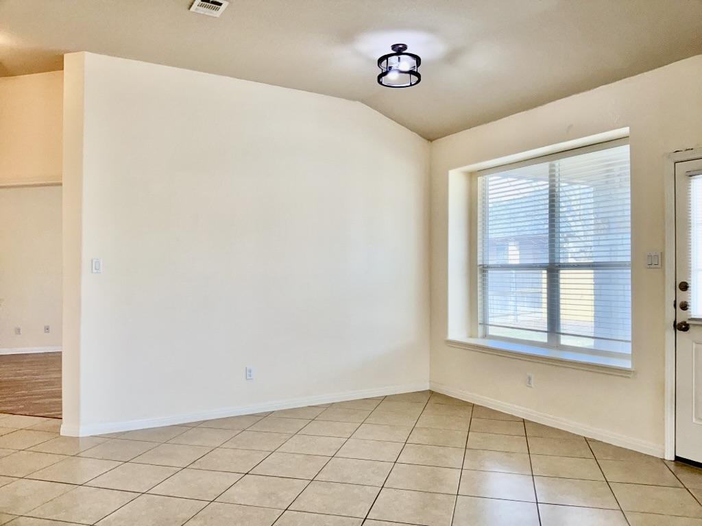 2946 Todd Trail Round Rock, TX 78665 - Photo 10 of 31 Dining Area with vaulted ceiling and light tile patterned flooring
