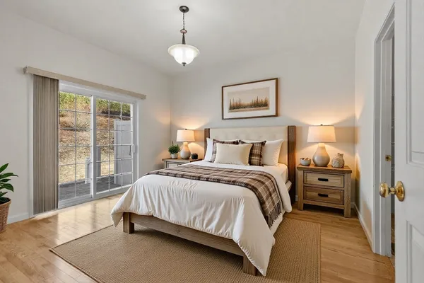 a kitchen with stainless steel appliances granite countertop a refrigerator a sink dishwasher a stove and white cabinets with wooden floor