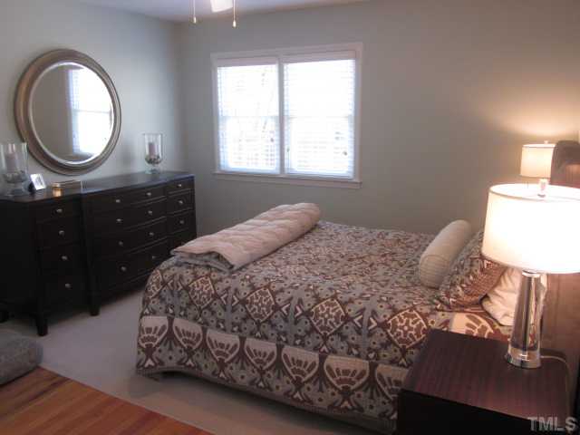 2031 Reaves Drive Raleigh, NC 27608 - Photo 20 of 25 Master bedroom features smooth ceiling, ceiling fan with light kit and hardwood floors! Cedar closet and full bathroom! Room is much larger that it looks!