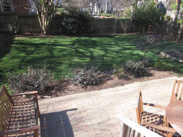 2031 Reaves Drive Raleigh, NC 27608 - Photo 6 of 25 Here is a lovely view of the fenced in back yard! Plenty of room for the kids and/or pets to run and play in this area! Cobble stone patio with rear covered entry into clean basement area!