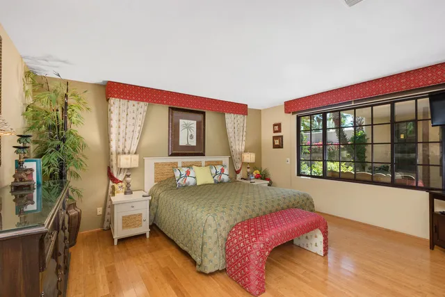 a bedroom with a large bed and a large window