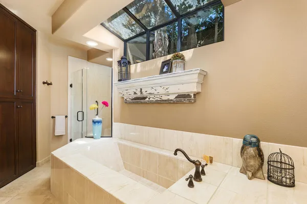 a bathroom with a tub sink and mirror