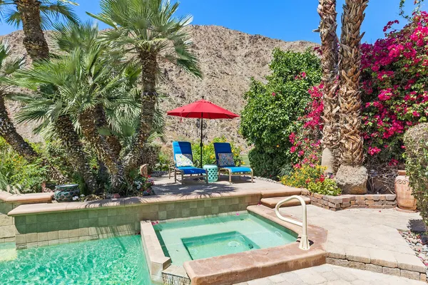 an outdoor space with patio furniture and white umbrellas