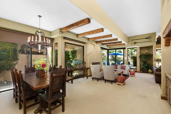a view of a dining room with furniture large windows and wooden floor