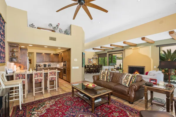 a living room with furniture a rug and a chandelier