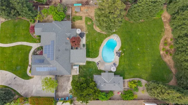 an aerial view of a house with a swimming pool and outdoor seating