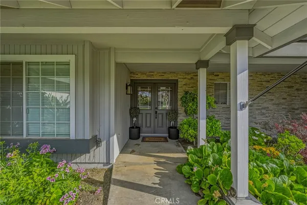 a house with potted plants in front of door