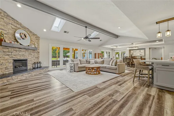 a living room with lots of furniture and view of kitchen