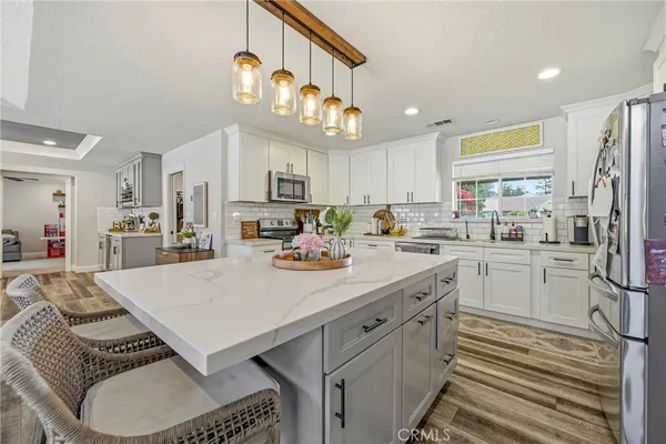 a kitchen with a sink appliances and cabinets