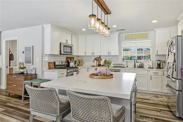 a kitchen with stainless steel appliances a sink and cabinets