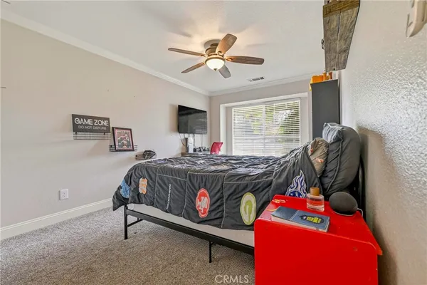 a bedroom with furniture and a baby crib
