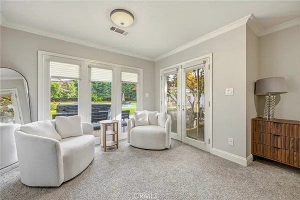 a view of a swimming pool with a table and chairs under an umbrella