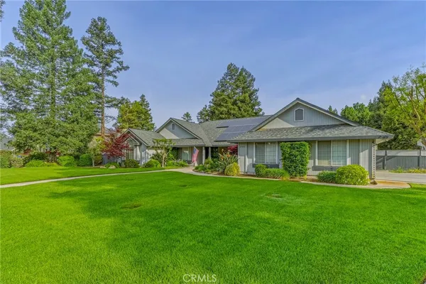 a front view of a house with a yard table and chairs