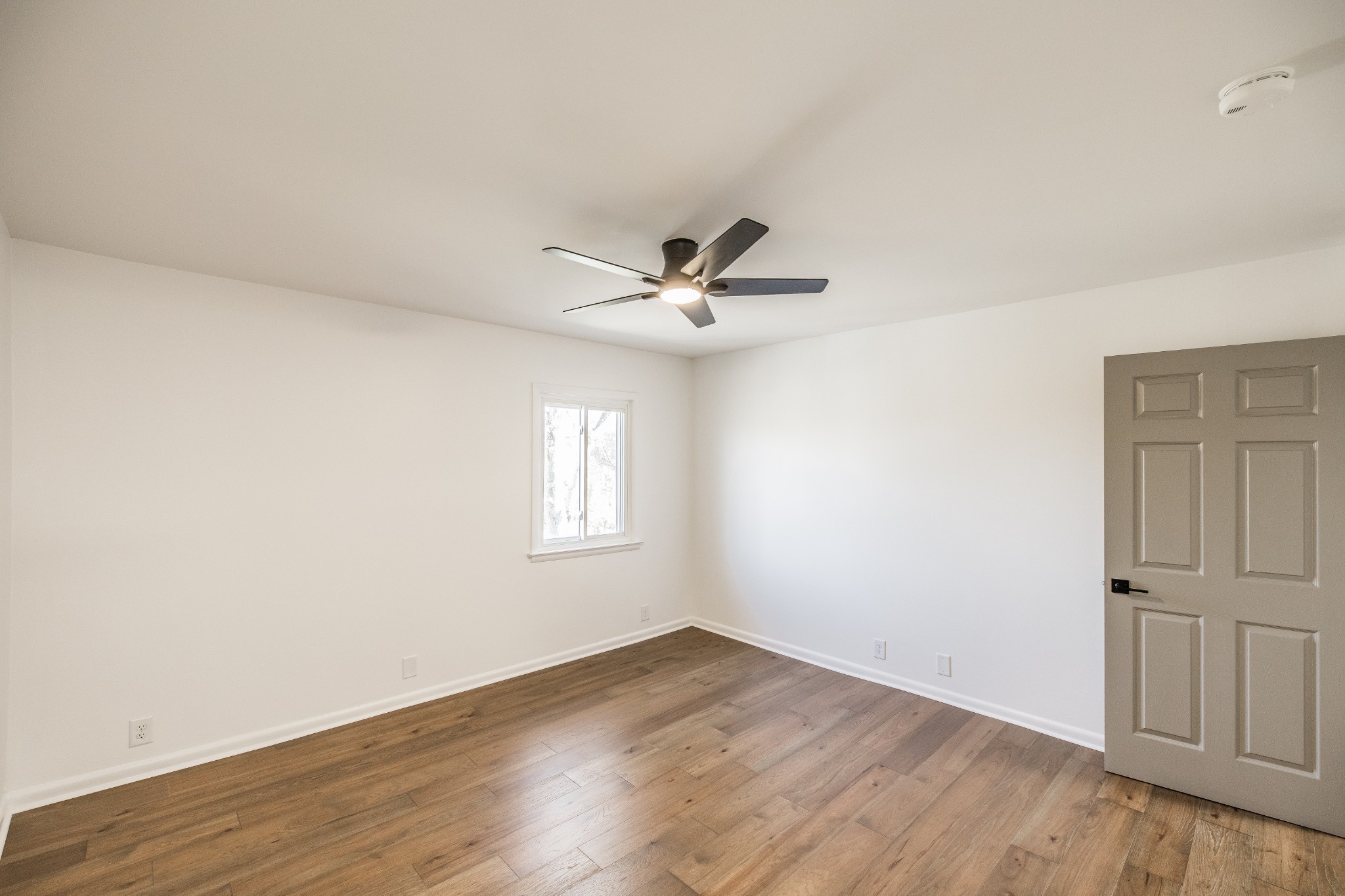 21 Vaughns Gap Road, Unit 55 Nashville, TN 37205 - Photo 26 of 35 an empty room with wooden floor fan and windows