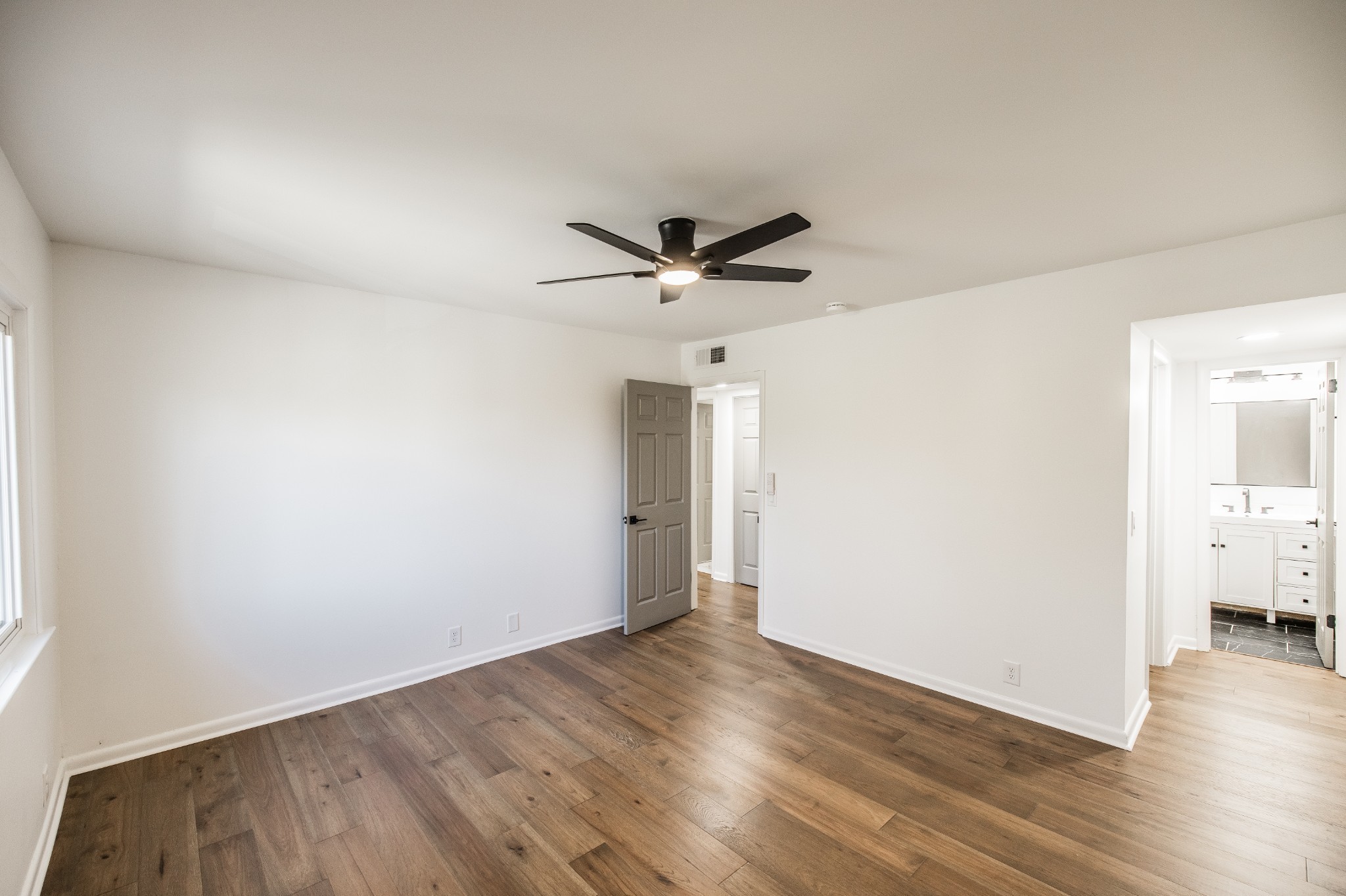 21 Vaughns Gap Road, Unit 55 Nashville, TN 37205 - Photo 27 of 35 an empty room with wooden floor and ceiling fan