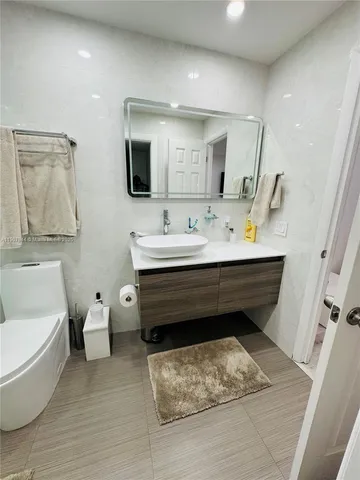 a spacious bathroom with a double vanity sink and a mirror