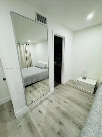 a bedroom with a bed and a mirror